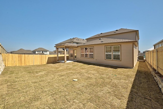 8004 Tranquil Glade Trl, Austin, TX 78744 - back of house featuring a shingled roof and a patio