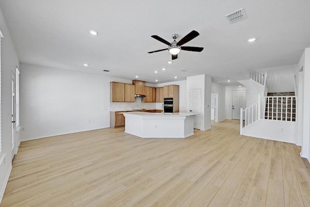 8004 Tranquil Glade Trl, Austin, TX 78744 - kitchen with open floor plan, ceiling fan, recessed lighting, light wood-style flooring, and tasteful backsplash