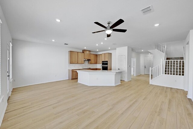 8004 Tranquil Glade Trl, Austin, TX 78744 - kitchen featuring open floor plan, ceiling fan, recessed lighting, light wood-style flooring, and decorative backsplash