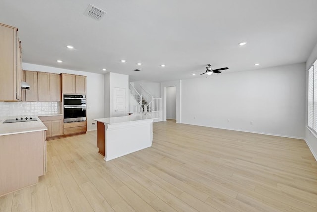 8004 Tranquil Glade Trl, Austin, TX 78744 - kitchen featuring black electric stovetop, stainless steel double oven, recessed lighting, ceiling fan, and light countertops