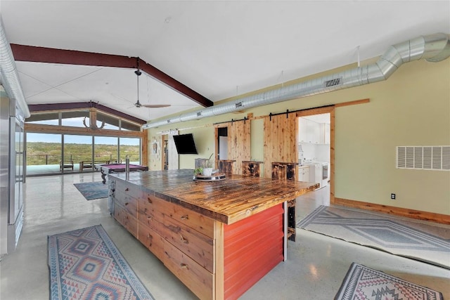 176 Elk Rdg, Canyon Lake, TX 78133 - kitchen featuring ceiling fan, finished concrete floors, lofted ceiling, visible vents, and butcher block counters