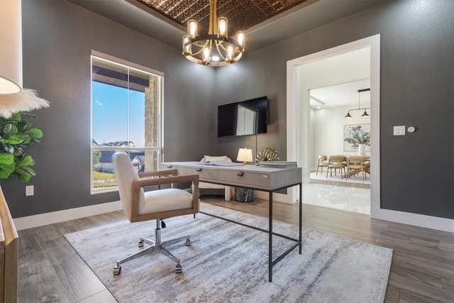 office with an ornate ceiling, baseboards, a notable chandelier, and wood finished floors