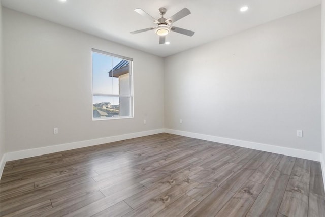 unfurnished room with recessed lighting, a ceiling fan, baseboards, and wood finished floors