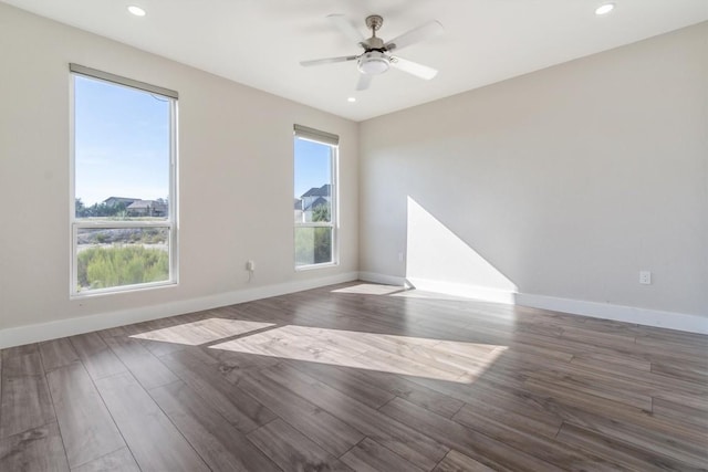 empty room with baseboards, recessed lighting, ceiling fan, and wood finished floors