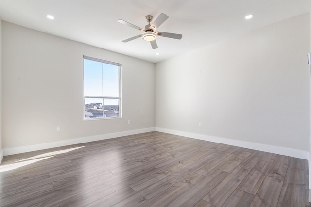 spare room featuring hardwood / wood-style flooring and ceiling fan