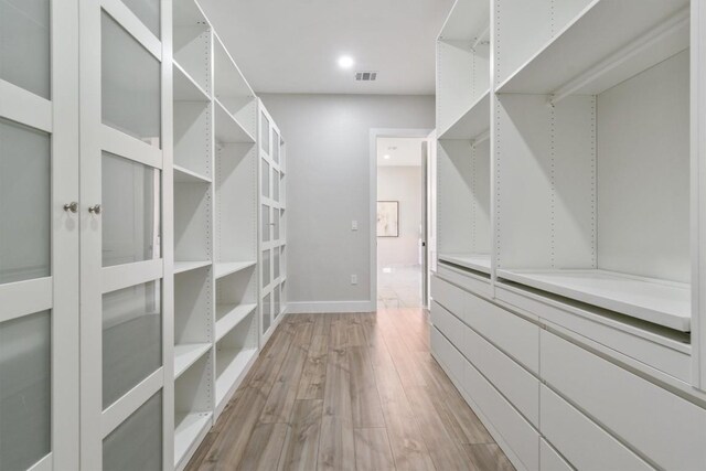 walk in closet featuring light hardwood / wood-style flooring