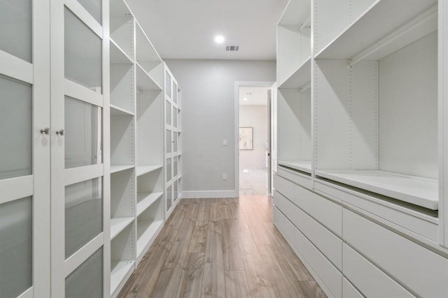 spacious closet featuring light wood finished floors and visible vents