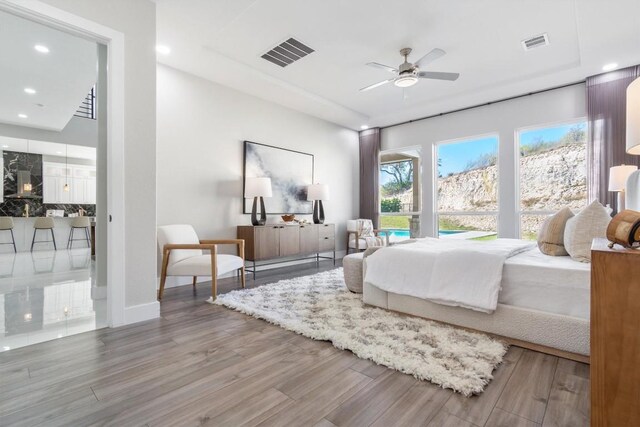 bedroom with ceiling fan and hardwood / wood-style floors