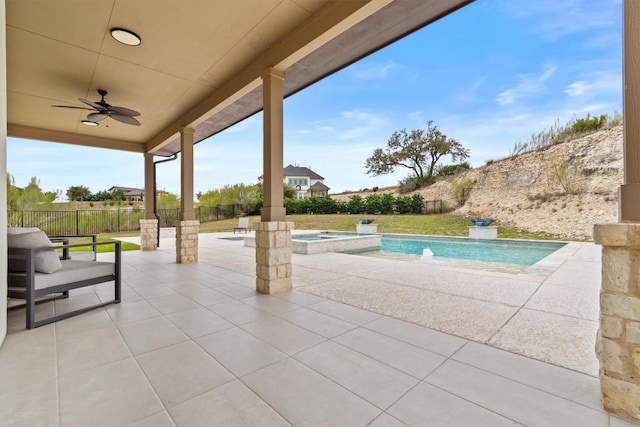 view of patio featuring a pool with connected hot tub, a ceiling fan, and a fenced backyard
