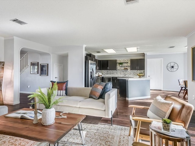 living room featuring ornamental molding, dark hardwood / wood-style floors, and sink