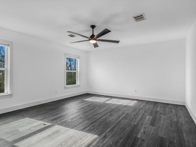 empty room with dark wood-type flooring and ceiling fan