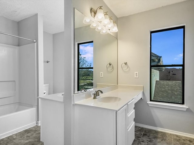 bathroom with vanity, bathing tub / shower combination, and a textured ceiling