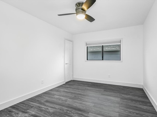 spare room with ceiling fan and dark hardwood / wood-style flooring