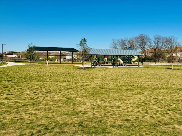 view of property's community with a playground and a yard