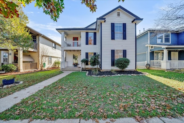 view of front of property featuring a balcony and a front lawn