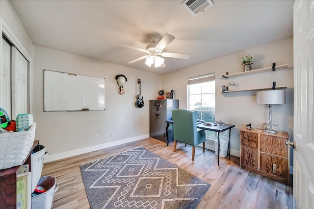 office space featuring ceiling fan and light wood-type flooring