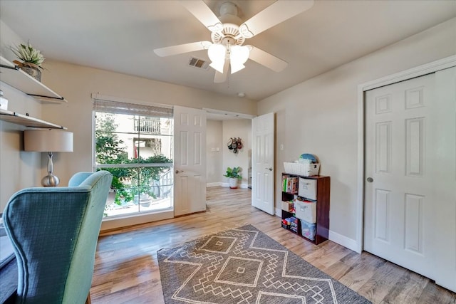 office space with a wealth of natural light, ceiling fan, and wood-type flooring