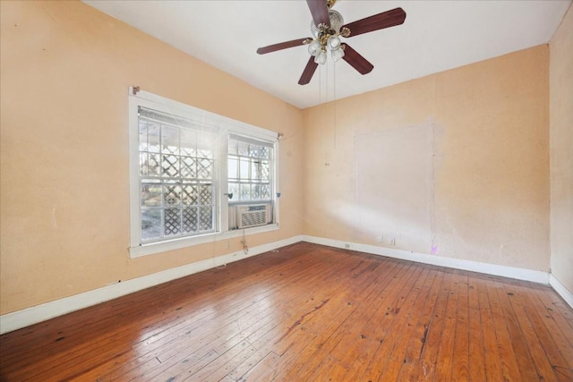 spare room featuring hardwood / wood-style floors, ceiling fan, and cooling unit