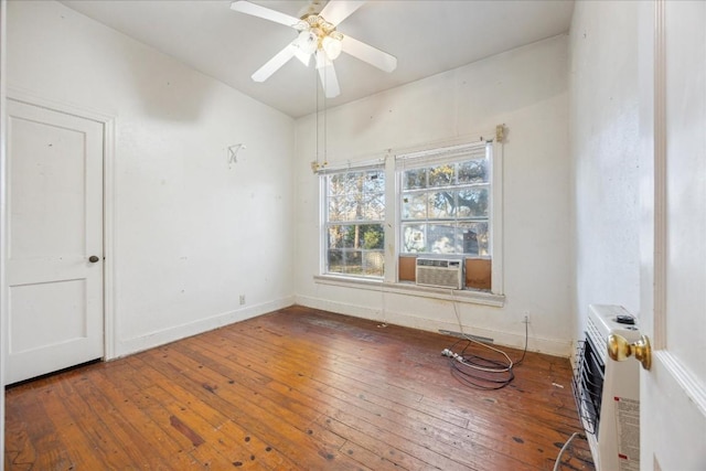 spare room featuring cooling unit, heating unit, ceiling fan, and dark wood-type flooring