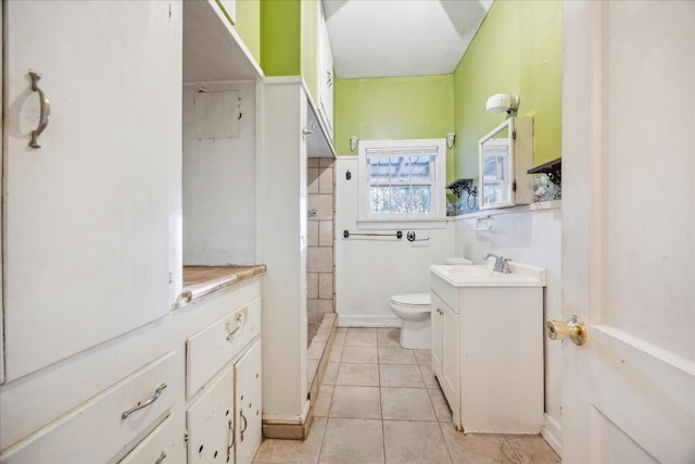 bathroom with tile patterned floors, vanity, and toilet