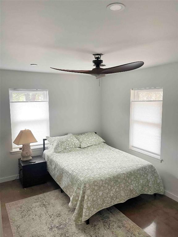 bedroom with hardwood / wood-style flooring and ceiling fan