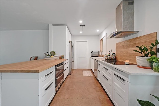 4505 Dudley Dr, Austin, TX 78735 - kitchen with wall chimney exhaust hood, stainless steel appliances, concrete flooring, white cabinets, and recessed lighting