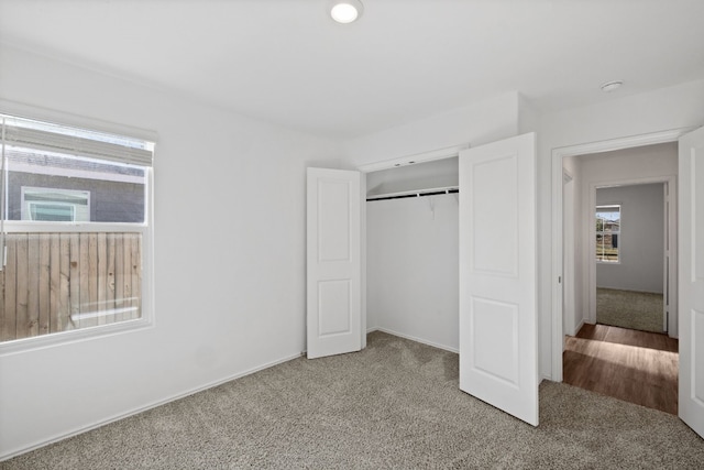 unfurnished bedroom with carpet floors and a closet