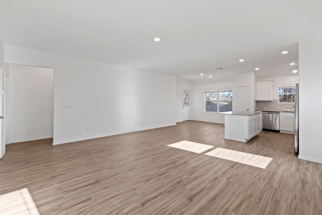 unfurnished living room featuring light hardwood / wood-style floors