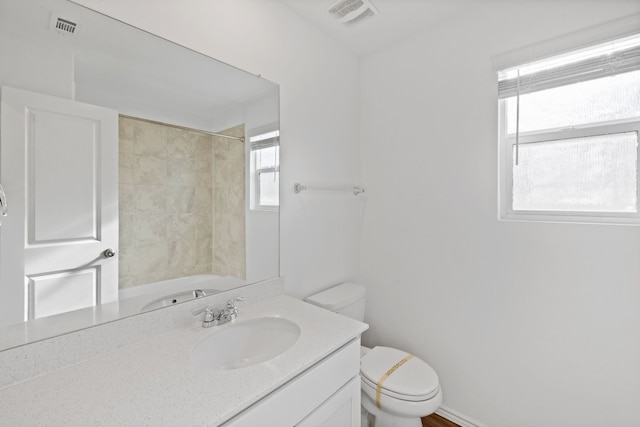 full bathroom with vanity, bathing tub / shower combination, and toilet