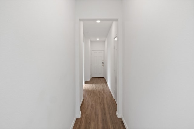 corridor with hardwood / wood-style floors