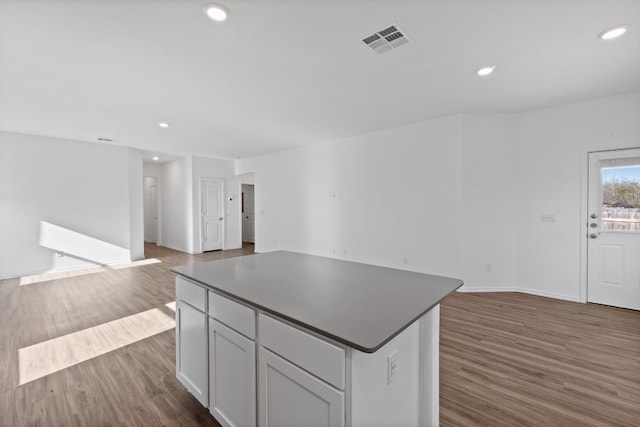 kitchen with a center island and dark wood-type flooring