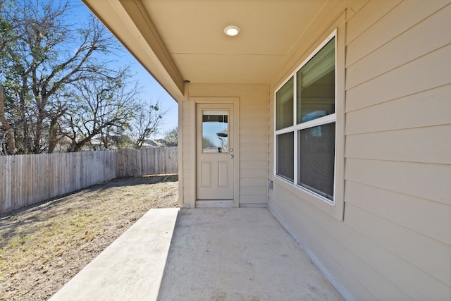 view of exterior entry with a patio