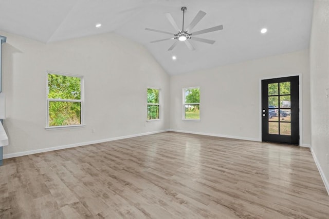 spare room with a wealth of natural light, light hardwood / wood-style flooring, ceiling fan, and high vaulted ceiling