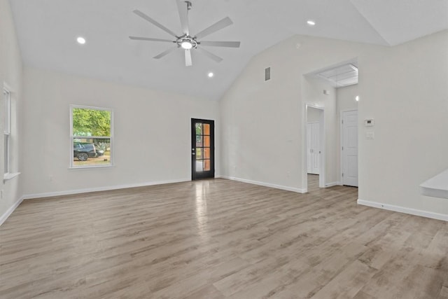 empty room with ceiling fan, light hardwood / wood-style floors, and high vaulted ceiling