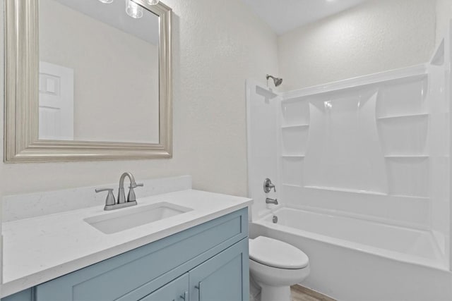 full bathroom with shower / tub combination, vanity, wood-type flooring, and toilet