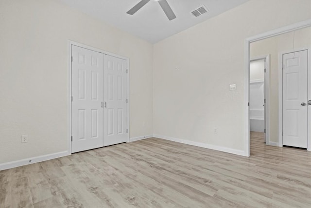 unfurnished bedroom with a closet, light hardwood / wood-style floors, and ceiling fan