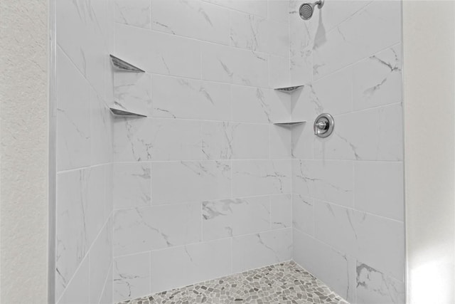 bathroom with tiled shower