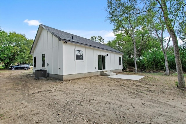 408 Griffin St, Luling, TX 78648 - rear view of house with board and batten siding, entry steps, a patio, and roof with shingles