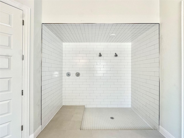 bathroom featuring tile patterned flooring and tiled shower