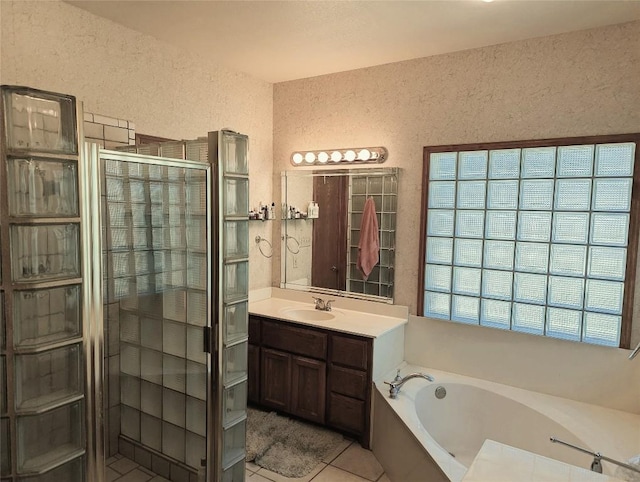 bathroom with tile patterned floors, vanity, and independent shower and bath