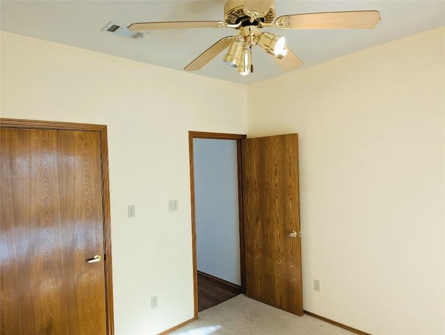 unfurnished bedroom featuring ceiling fan and light carpet