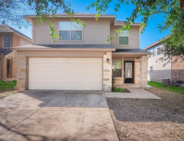 view of front property featuring a garage and central air condition unit