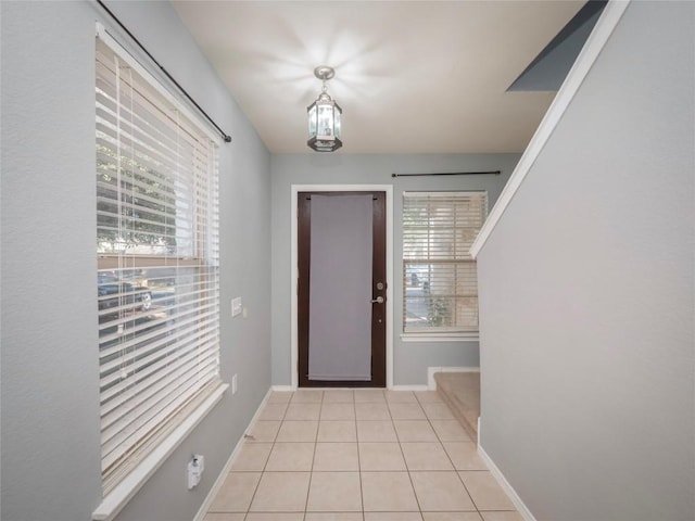 entrance foyer featuring a chandelier and light tile patterned flooring