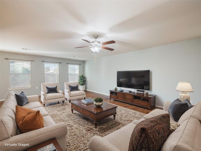 living room featuring ceiling fan and light hardwood / wood-style flooring