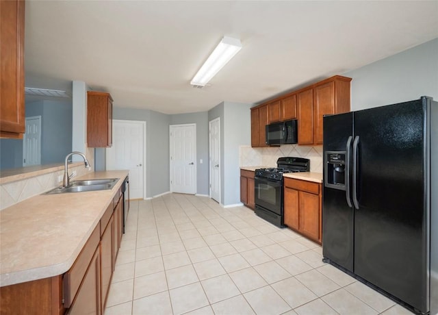 kitchen with sink, backsplash, kitchen peninsula, light tile patterned flooring, and black appliances