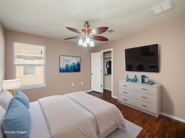 bedroom with ceiling fan, a closet, and dark wood-type flooring