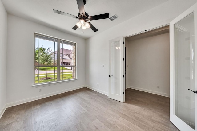 2204 Bayridge Rd, Georgetown, TX 78628 - unfurnished bedroom featuring light wood finished floors, french doors, and a ceiling fan