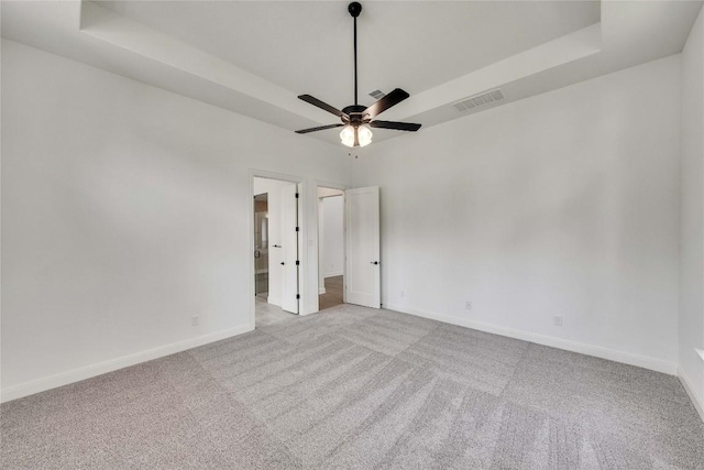 2204 Bayridge Rd, Georgetown, TX 78628 - unfurnished room featuring a tray ceiling, carpet floors, and a ceiling fan