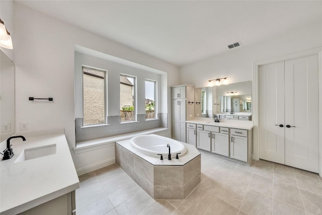 2204 Bayridge Rd, Georgetown, TX 78628 - full bath featuring two vanities, tile patterned flooring, and a bath
