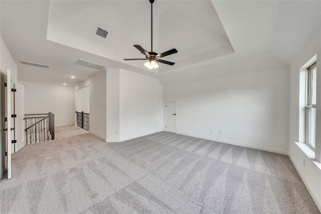 2204 Bayridge Rd, Georgetown, TX 78628 - empty room with carpet, a ceiling fan, healthy amount of natural light, and a tray ceiling
